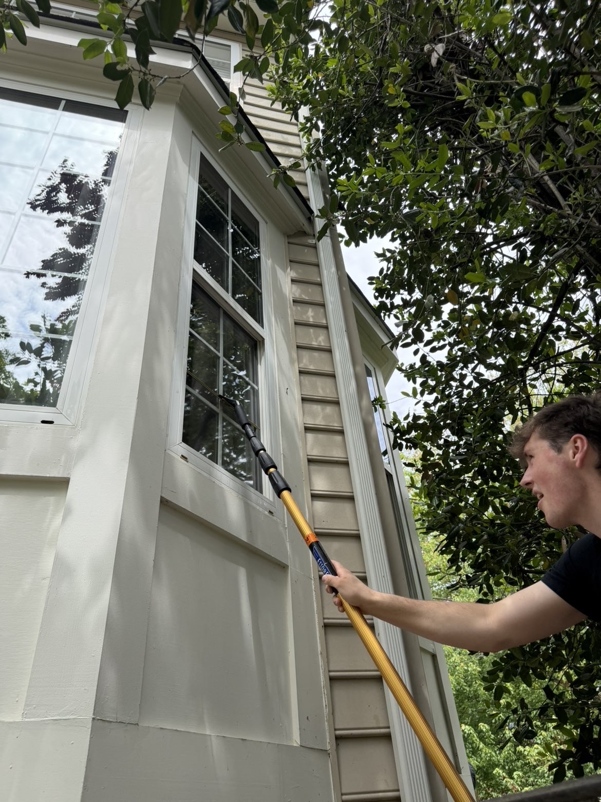 Blue Line Co. cleaning exterior windows from ground level
